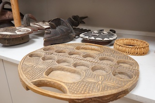 Three African tribal masks and a carved folding tray, largest 92cm. Condition - fair to good